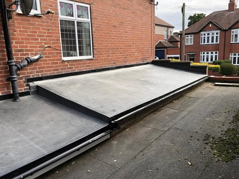 Rubber EPDM flat roof with new black trims and guttering
