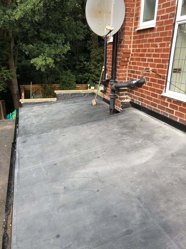 Flat roof around soil pipe with neat lead and trim work