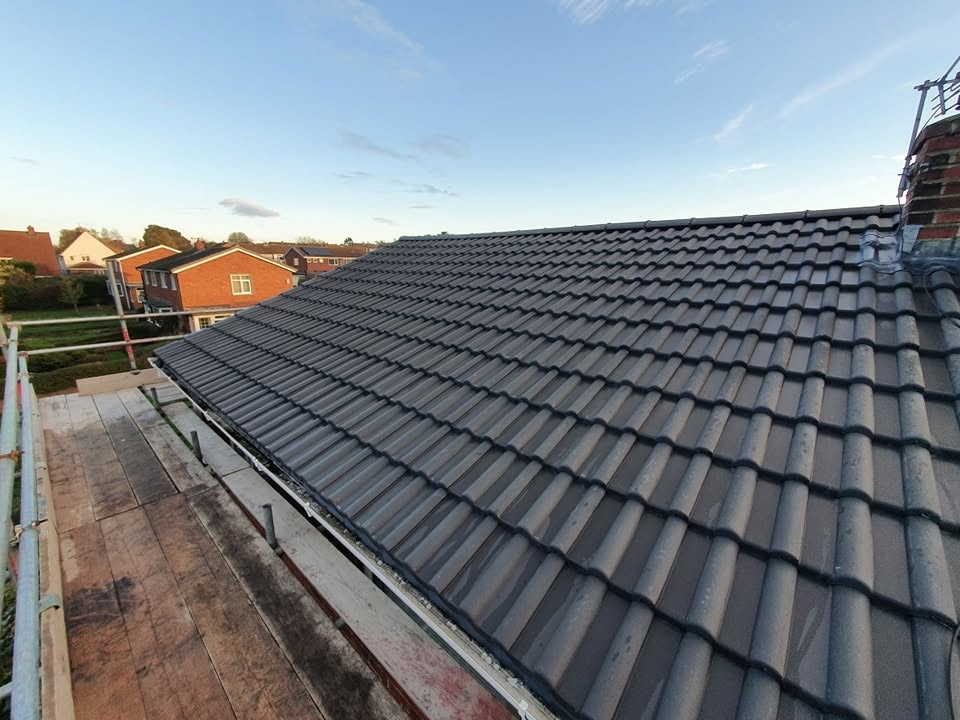 Close view of new interlocking roof tiles and dry ridge