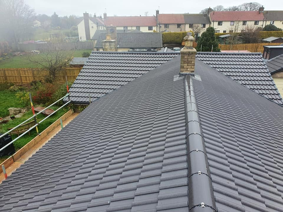 Completed hipped roof re-tile with new ridge tiles